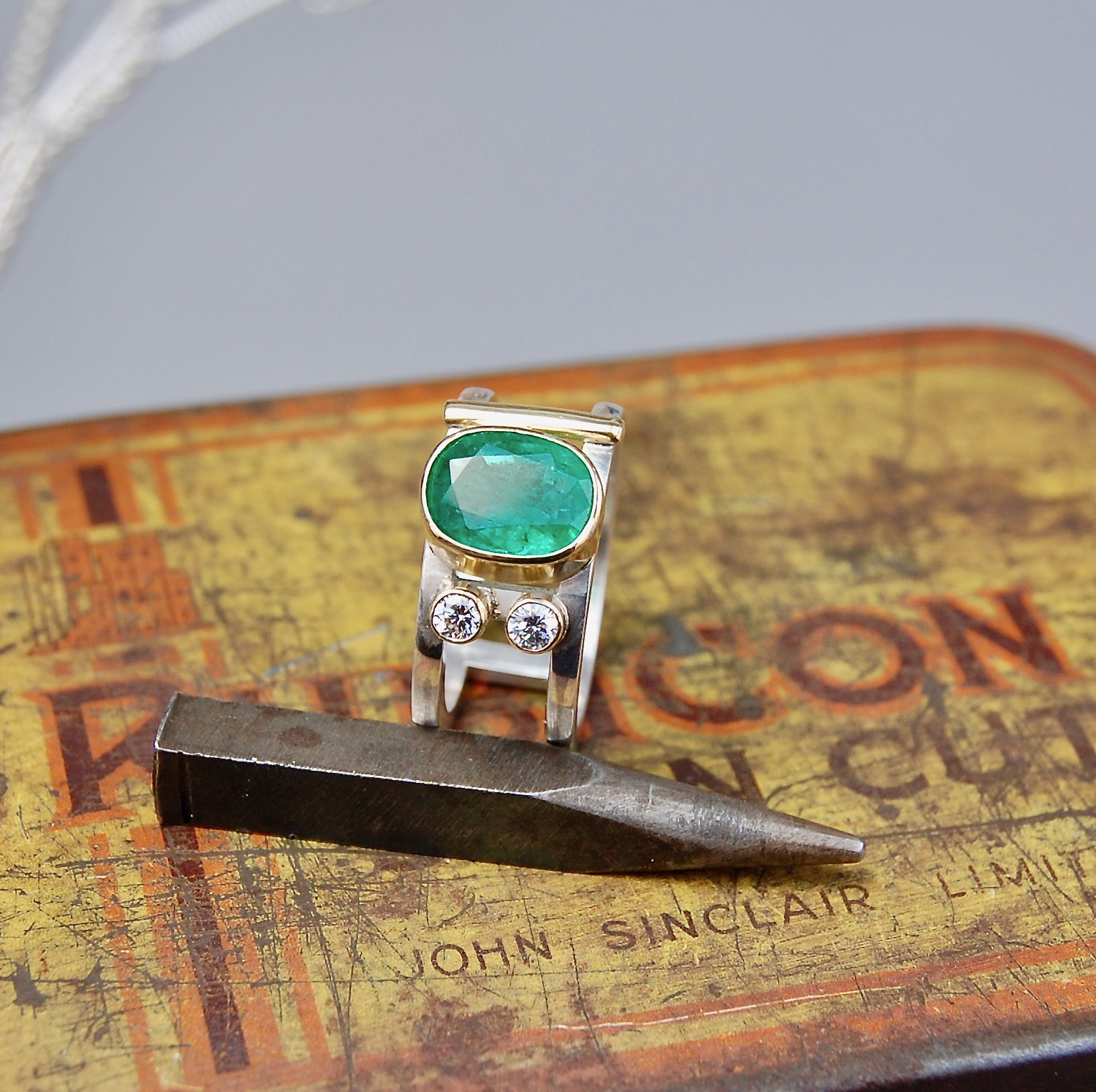 Emerald and diamonds set in 18ct gold on silver ring