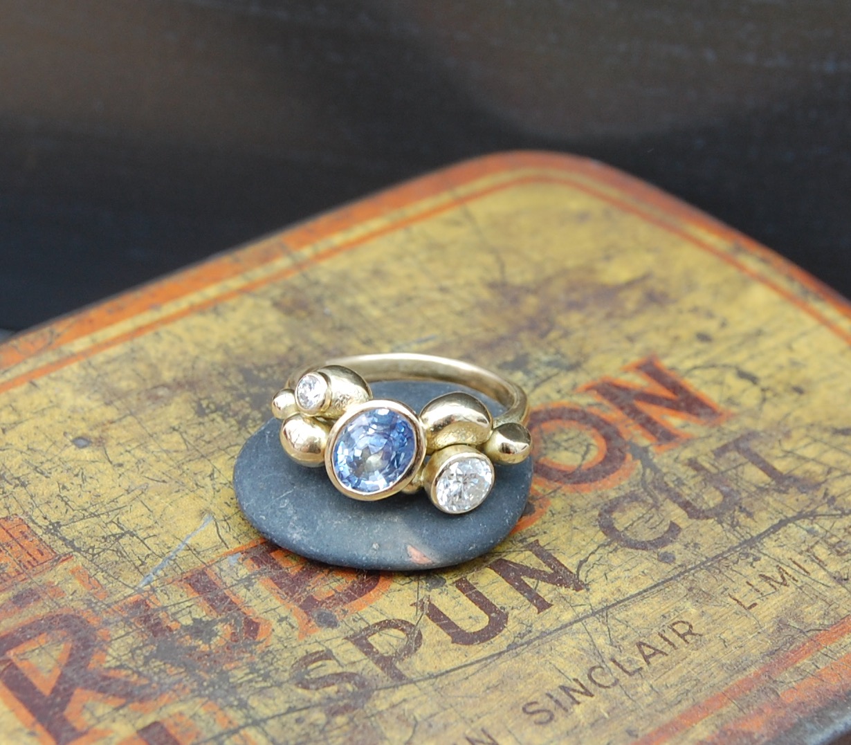 Sapphire and diamonds set in 18ct gold cup settings grouped with gold clusters